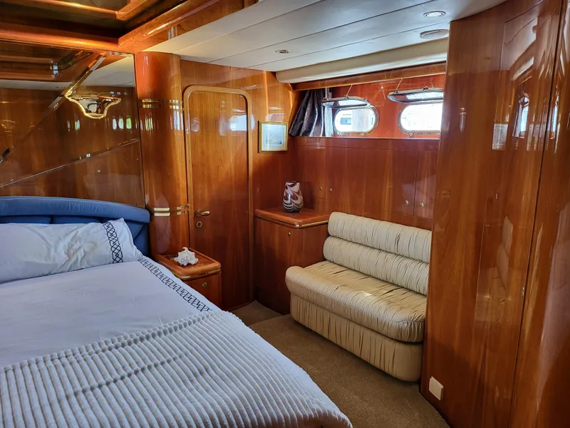 Slide: The Image of Luxurious cabin interior of 2000 Horizon 74 Motor Yacht with wood paneling and cozy seating. - 29