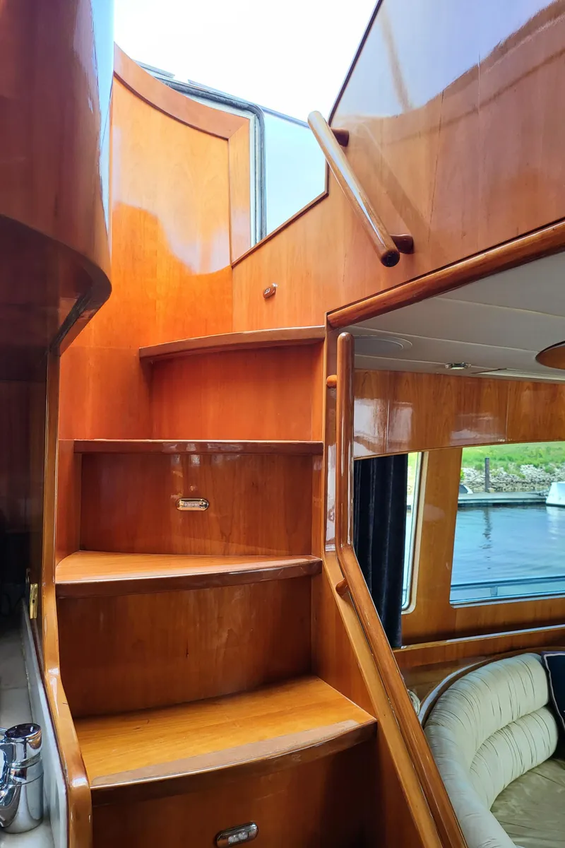 Slide: The Image of Wooden staircase inside 2000 Horizon 74 Motor Yacht, leading to upper deck. - 38
