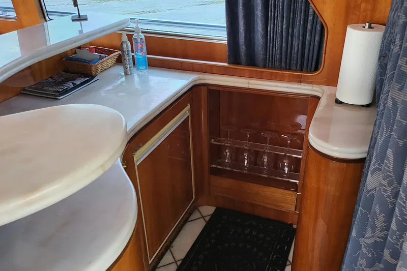 Slide: The Image of Luxurious interior of 2000 Horizon 74 Motor Yacht with elegant wood cabinetry and countertop. - 41