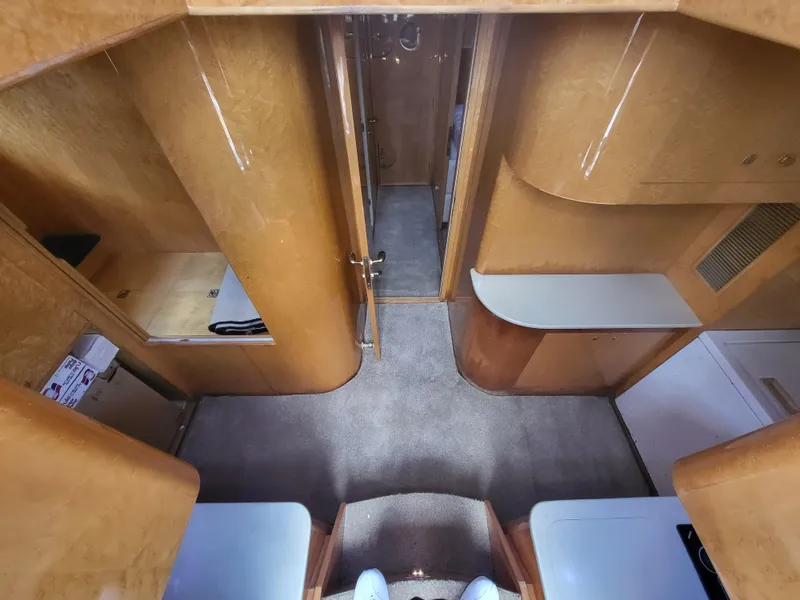 Slide: The Image of Interior view of a 2000 Horizon 74 Motor Yacht, featuring wood paneling and carpeted flooring. - 49