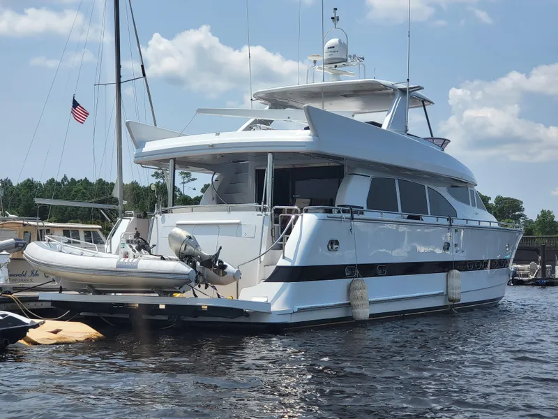 Slide: The Image of Horizon 74 Motor Yacht 2000 docked, featuring sleek design and inflatable boat on deck. - 5