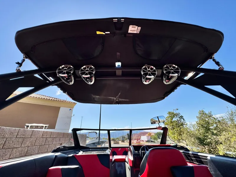 Slide: The Image of 2022 Tigé ATX 24 Type s boat interior with speakers and red seating. - 17