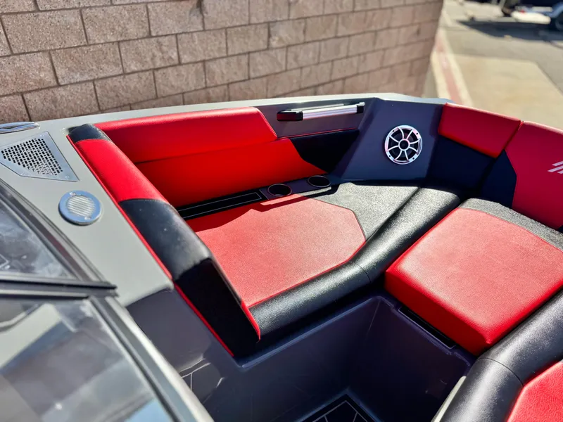 Slide: The Image of 2022 Tigé ATX 24 Type s boat interior with red and black seating, speaker, and cup holder. - 21