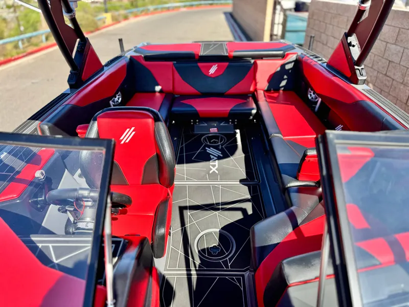 Slide: The Image of 2022 Tigé ATX 24 Type s boat interior with red and black seating, modern design. - 23