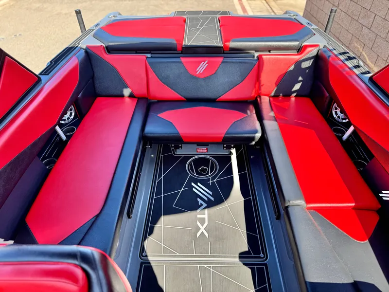 Slide: The Image of 2022 Tigé ATX 24 Type s boat interior with red and black seating. - 24