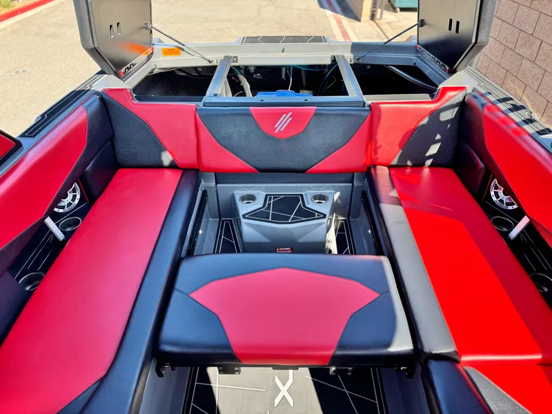 Slide: The Image of 2022 Tigé ATX 24 Type s boat interior with red and black seating. - 26