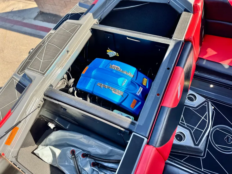 Slide: The Image of 2022 Tigé ATX 24 Type s boat engine compartment with vibrant blue engine cover. - 28