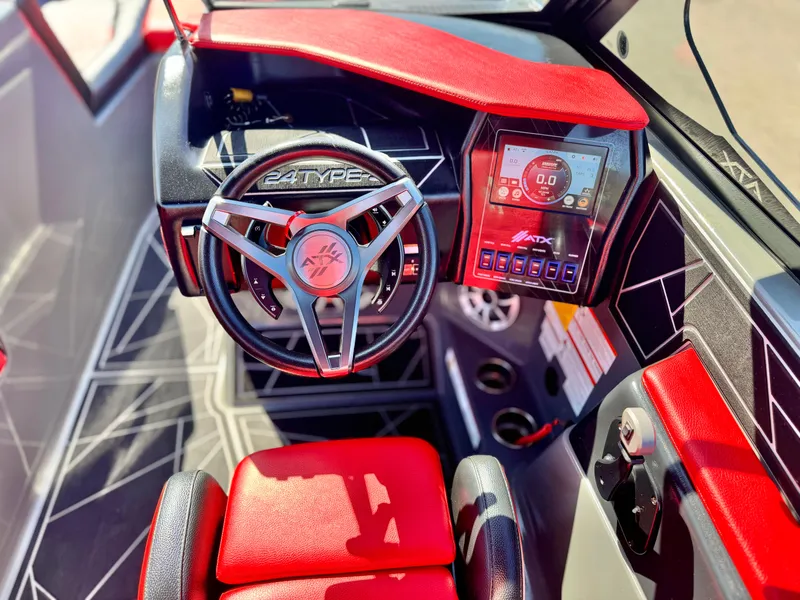 Slide: The Image of 2022 Tigé ATX 24 Type s boat interior with red accents and modern dashboard. - 35