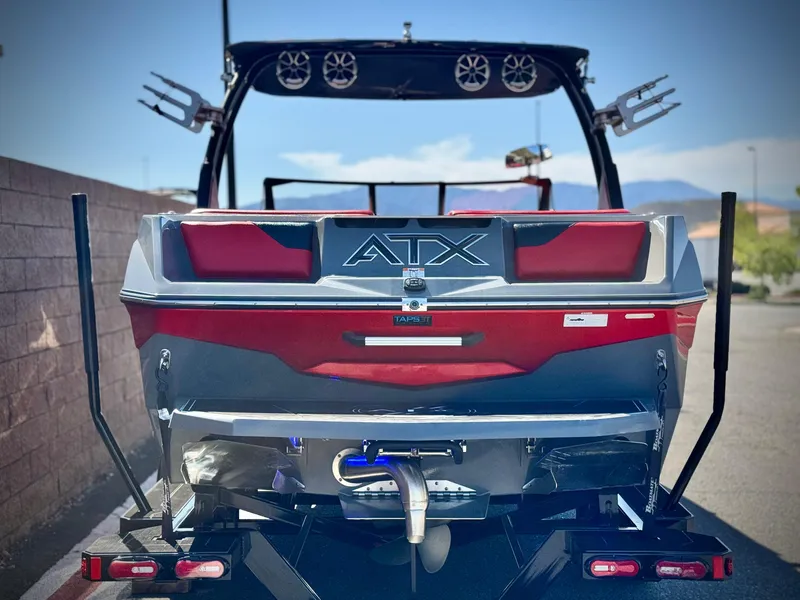 Slide: The Image of 2022 Tigé ATX 24 Type s boat, rear view, on trailer, with speakers and wakeboard racks. - 4