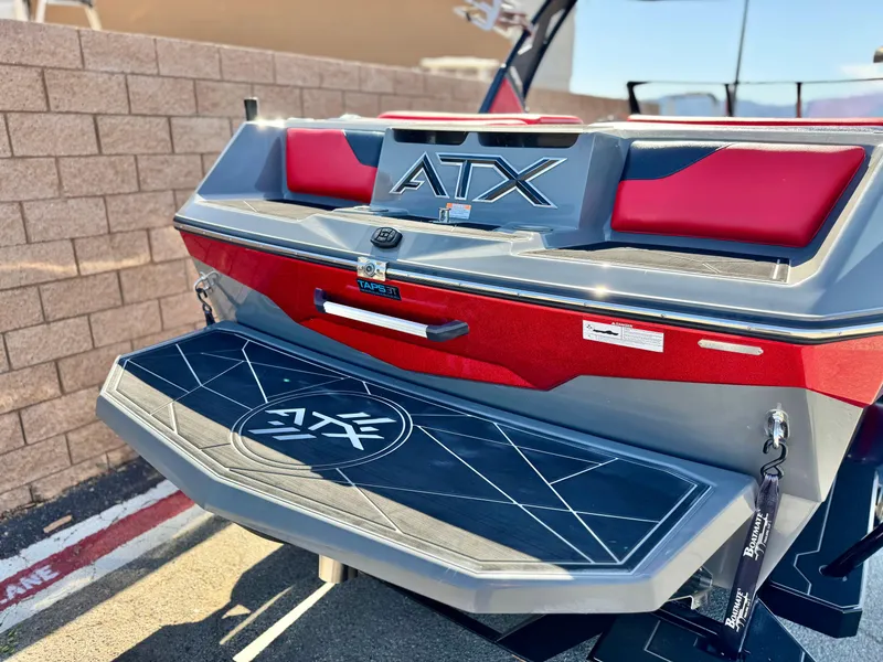 Slide: The Image of 2022 Tigé ATX 24 Type s boat rear view with red and gray detailing. - 6