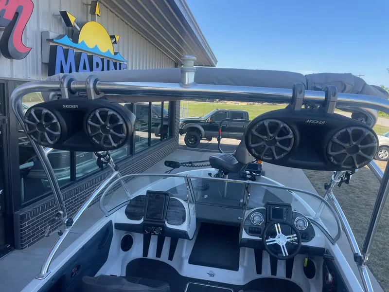 Slide: The Image of 2014 Ranger 211 VS boat with mounted speakers at a marina. - 3