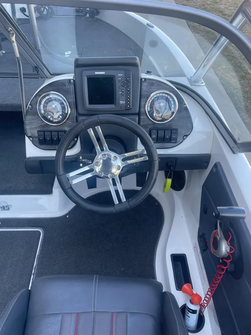 Slide: The Image of 2014 Ranger 211 VS boat dashboard with steering wheel and navigation system. - 5