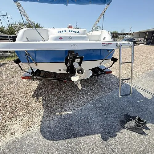 Slide: The Image of 2012 Hurricane 201 Sundeck Sport boat, rear view with ladder and shoes on ground. - 10