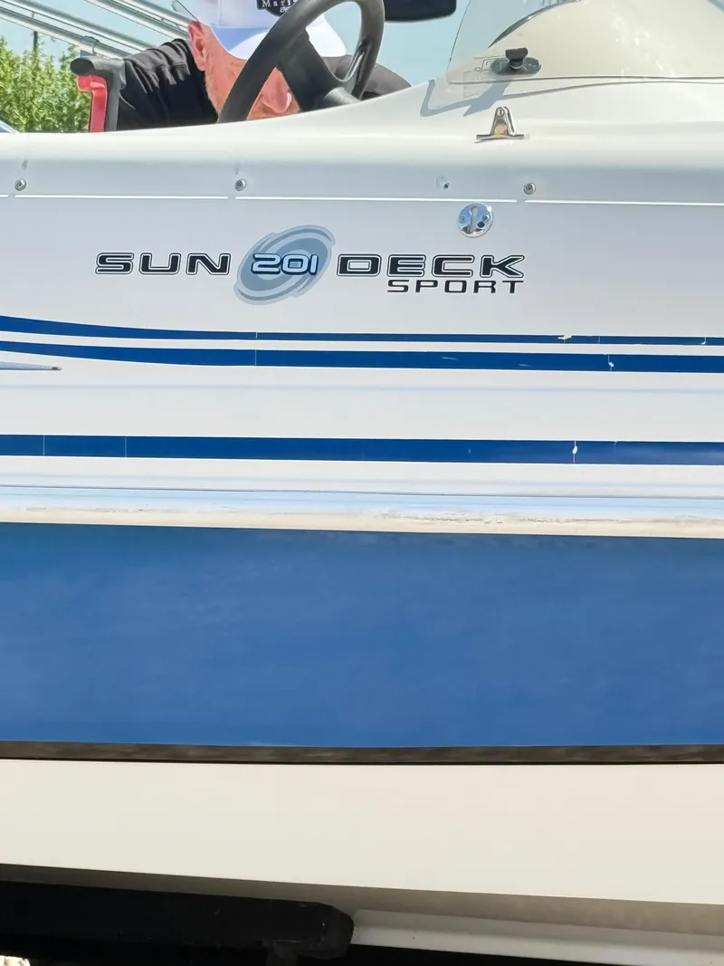 Slide: The Image of 2012 Hurricane 201 Sundeck Sport boat with blue and white design. - 5