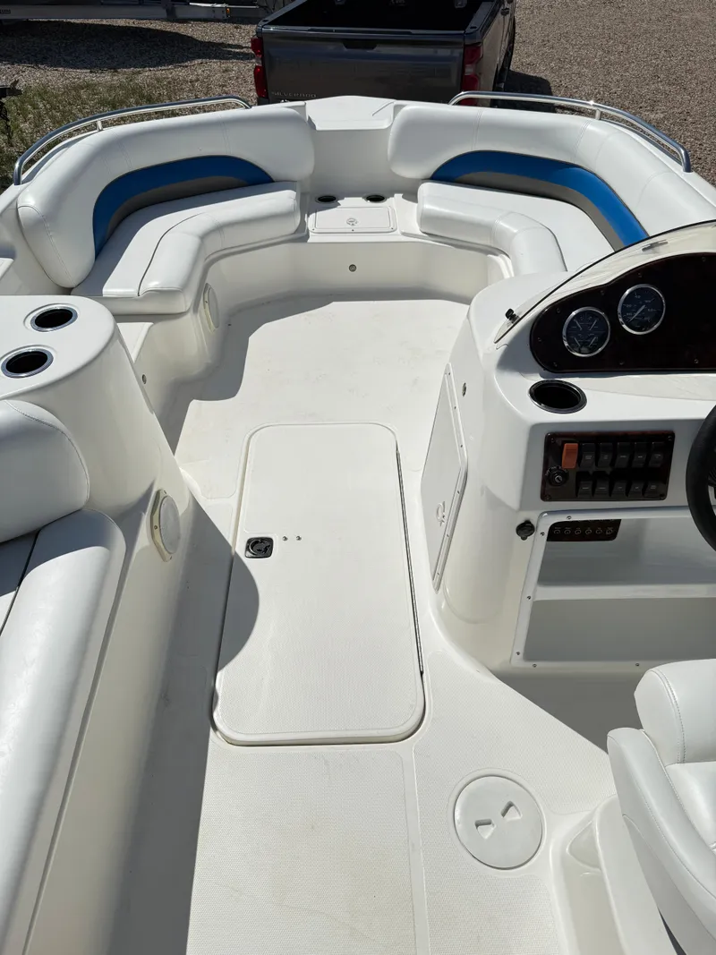 Slide: The Image of 2012 Hurricane 201 Sundeck Sport boat interior with white seating and control panel. - 6