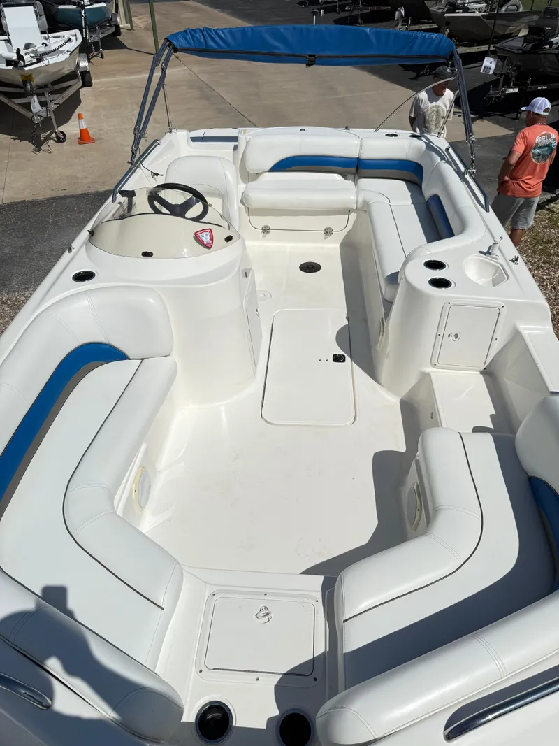 Slide: The Image of 2012 Hurricane 201 Sundeck Sport boat with spacious seating and blue canopy. - 7