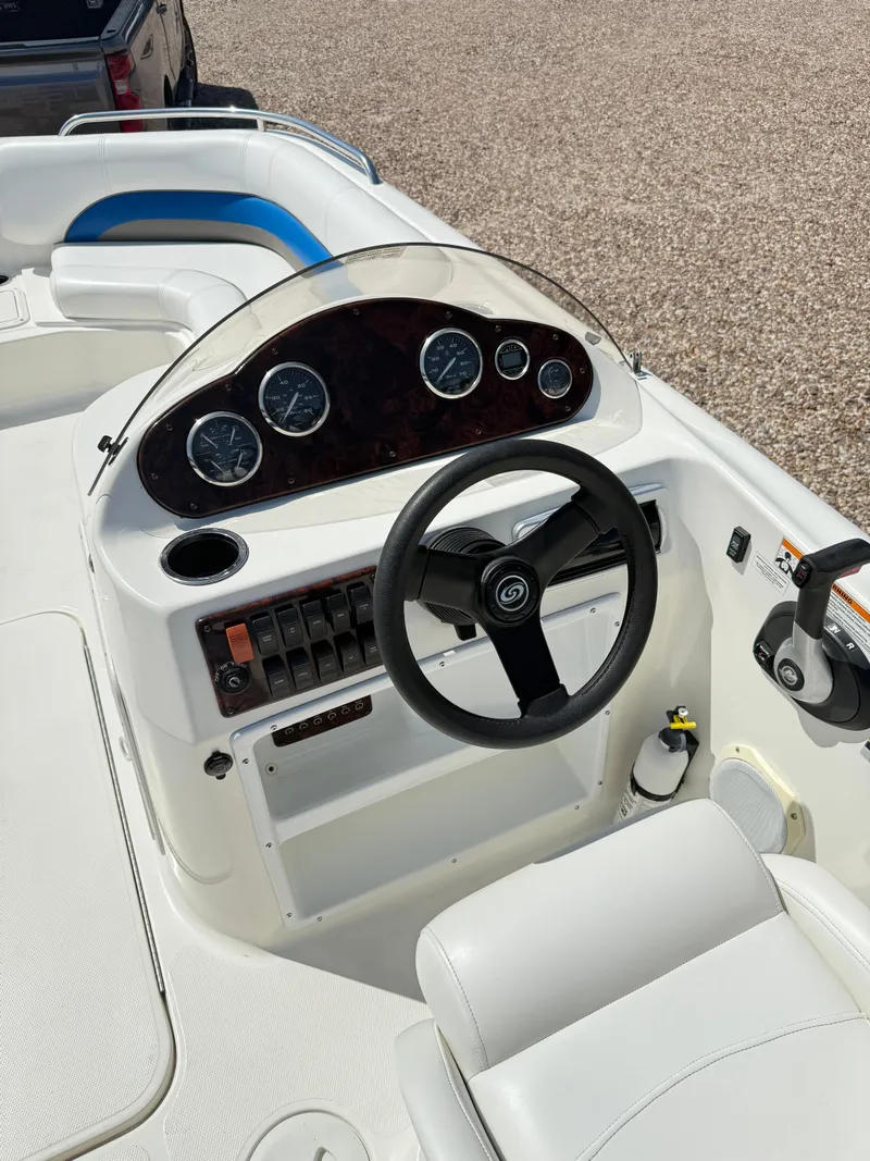 Slide: The Image of 2012 Hurricane 201 Sundeck Sport boat dashboard with steering wheel and gauges. - 8