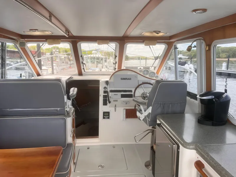 Slide: The Image of Interior of 2006 True North 38' Heritage boat with helm and seating area. - 34