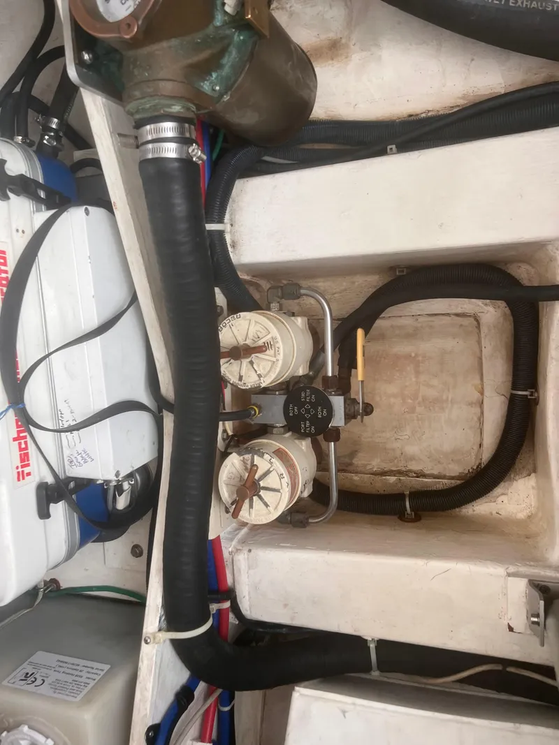 Slide: The Image of Engine compartment of a 2006 True North 38' Heritage boat, showing hoses and filters. - 45