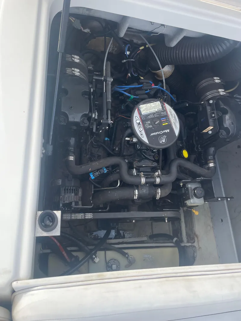 Slide: The Image of Engine compartment of a 2011 Bayliner 197 boat, showcasing the motor and components. - 13