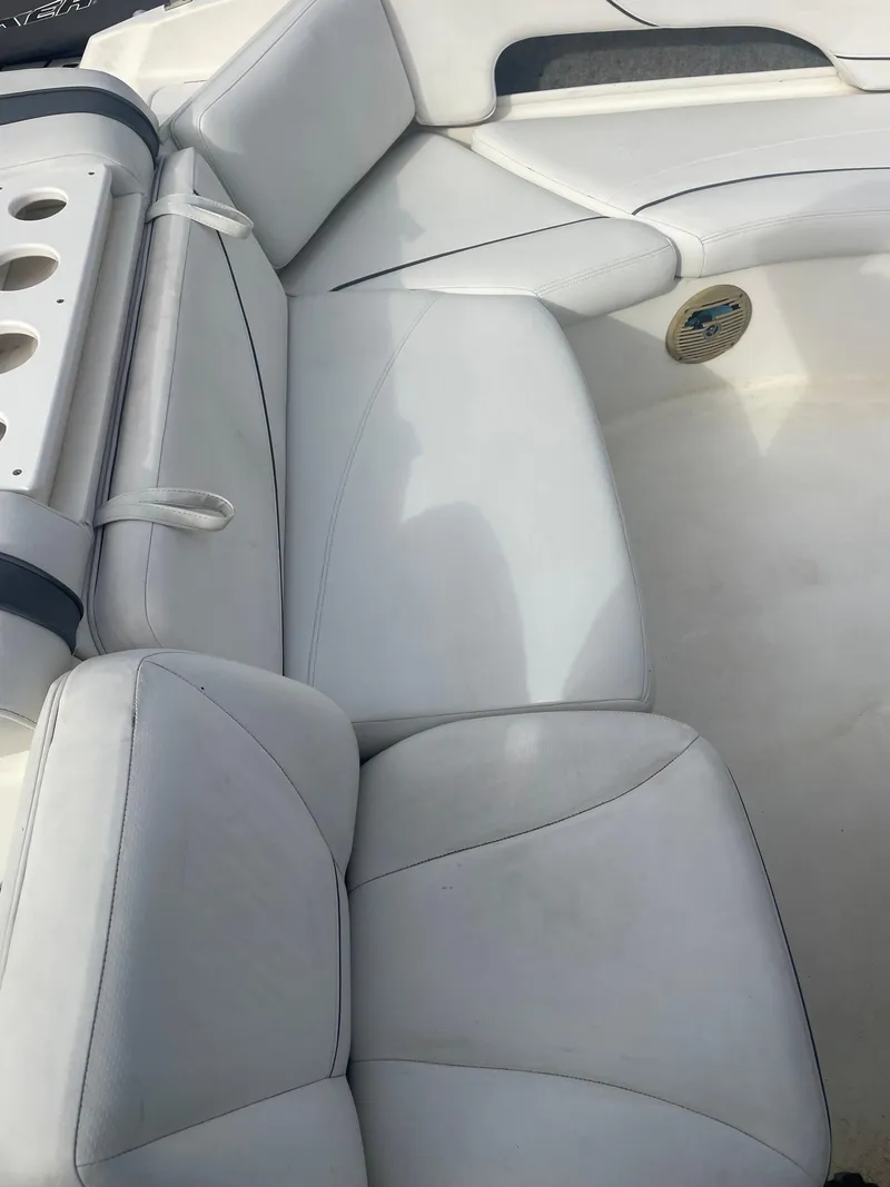 Slide: The Image of 2011 Bayliner 197 boat interior with white cushioned seating. - 14