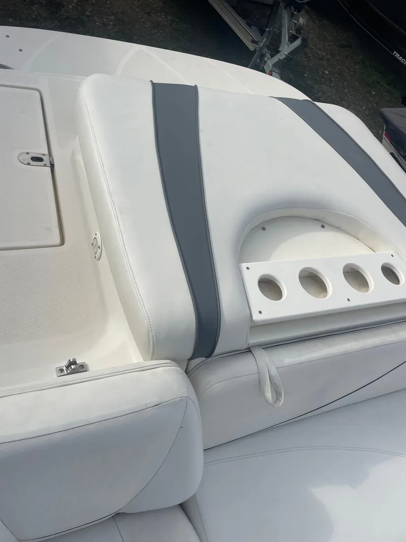 Slide: The Image of 2011 Bayliner 197 boat interior with white and gray seating. - 15