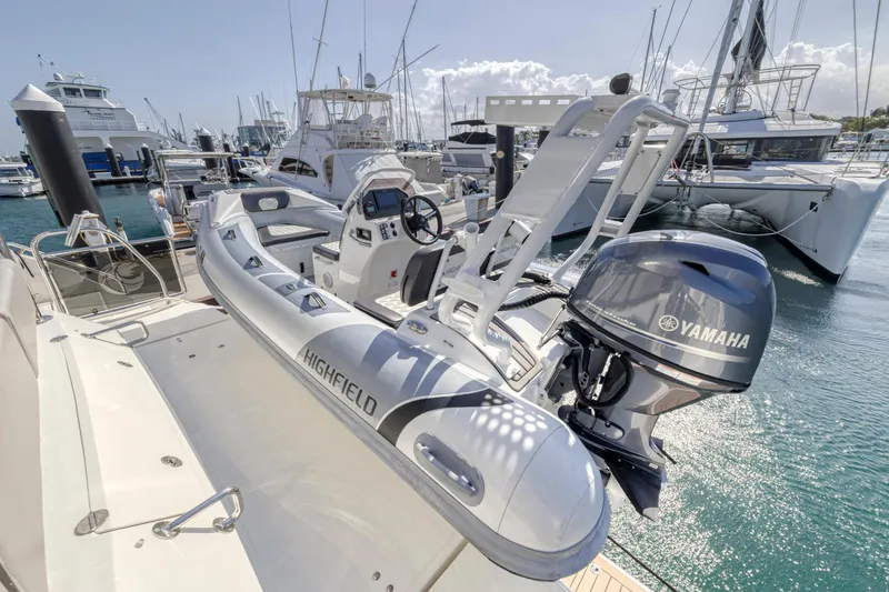 Slide: The Image of 2023 Aquila 54 Yacht docked in a scenic canal with lush greenery. - 104