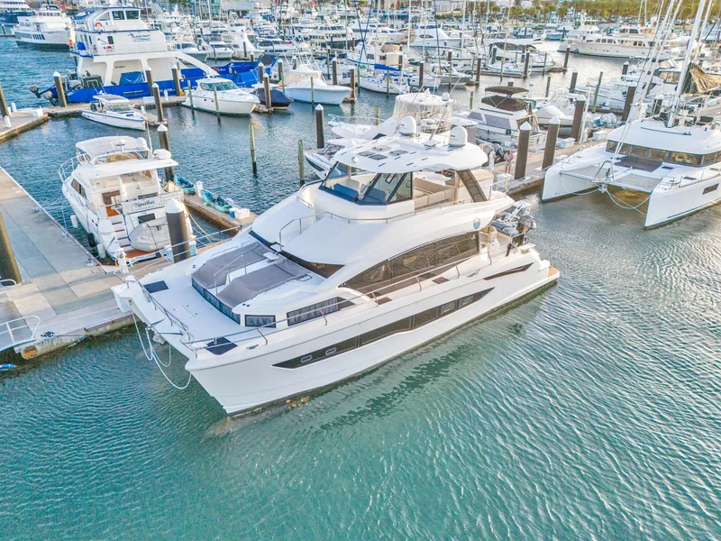 Slide: The Image of Aerial view of 2023 Aquila 54 Yacht docked in turquoise water. - 124