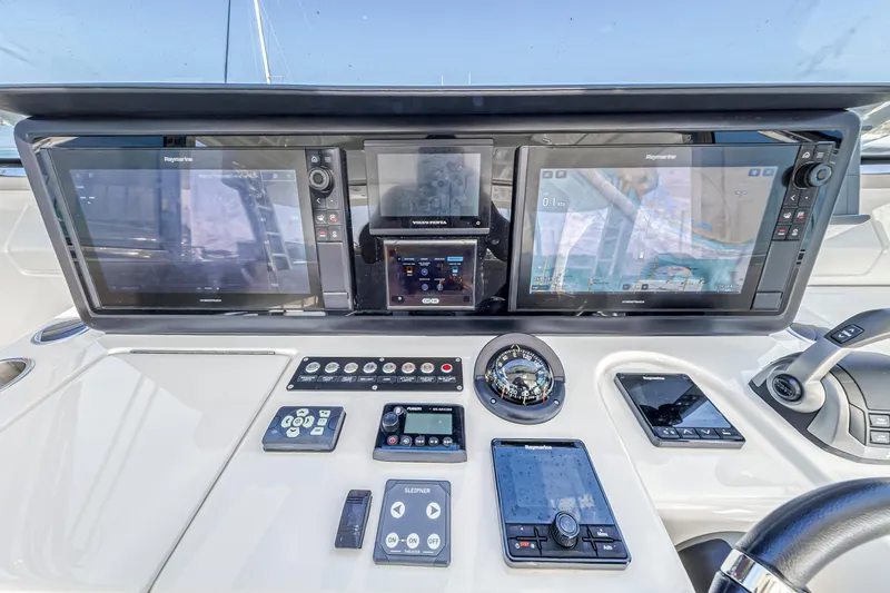 Slide: The Image of Cockpit view of 2023 Aquila 54 Yacht with modern navigation equipment and ocean backdrop. - 13
