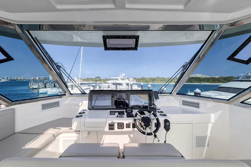 Slide: The Image of 2023 Aquila 54 Yacht cockpit with modern navigation systems and luxurious seating. - 15