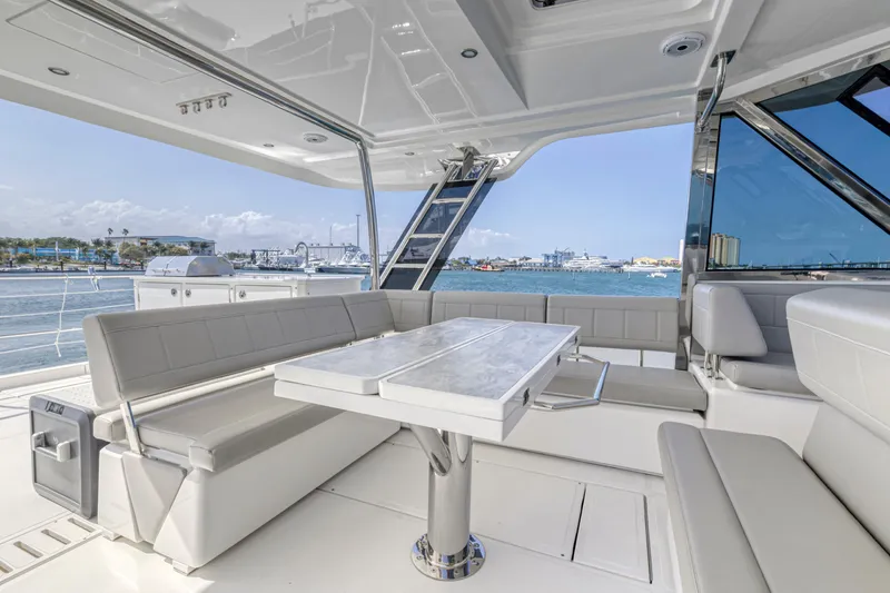 Slide: The Image of Aquila 54 Yacht 2023, spacious deck view, docked at marina with other boats. - 23