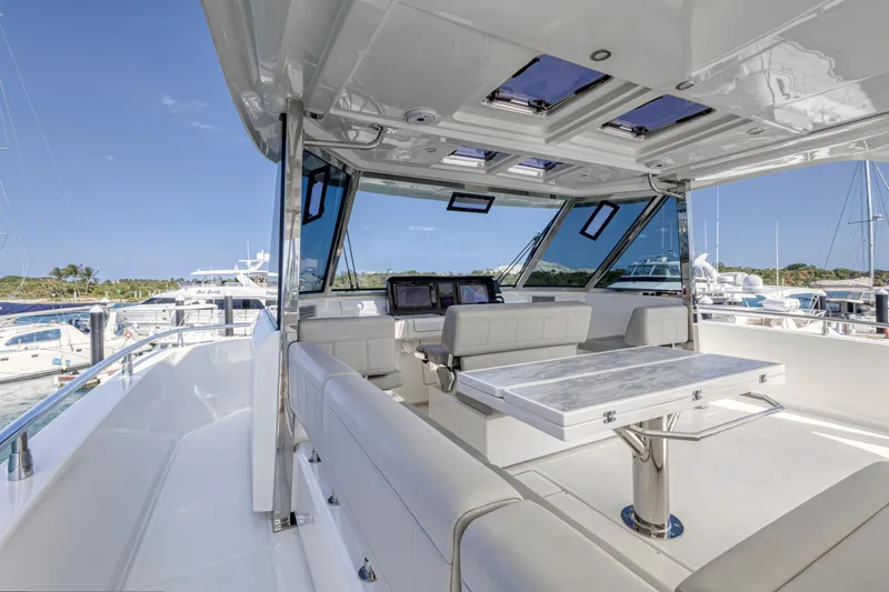 Slide: The Image of Luxurious 2023 Aquila 54 Yacht interior with modern seating and ocean view. - 27