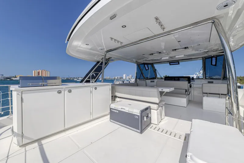 Slide: The Image of 2023 Aquila 54 Yacht deck with seating, table, and ocean view. - 29