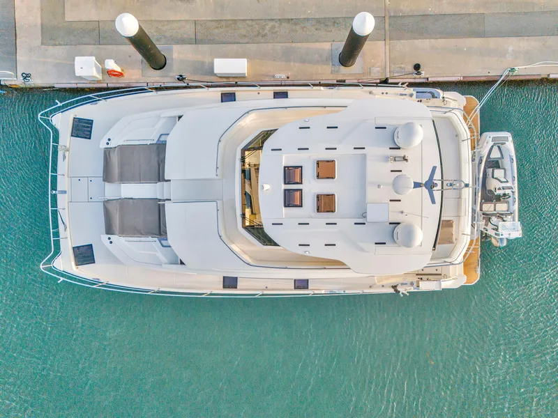 Slide: The Image of Top view of 2023 Aquila 54 Yacht docked, showcasing spacious deck and sleek design. - 3