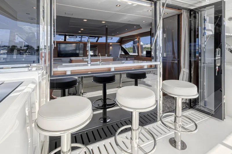 Slide: The Image of Control panel inside 2023 Aquila 54 Yacht, featuring modern wood finish and marina view. - 34