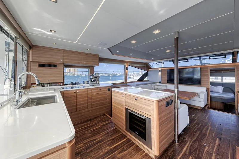 Slide: The Image of Interior of 2023 Aquila 54 Yacht with wooden cabinetry and ocean view window. - 39