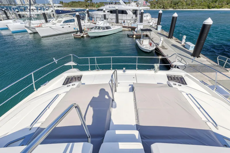 Slide: The Image of 2023 Aquila 54 Yacht docked, showcasing sleek design and spacious deck. - 44