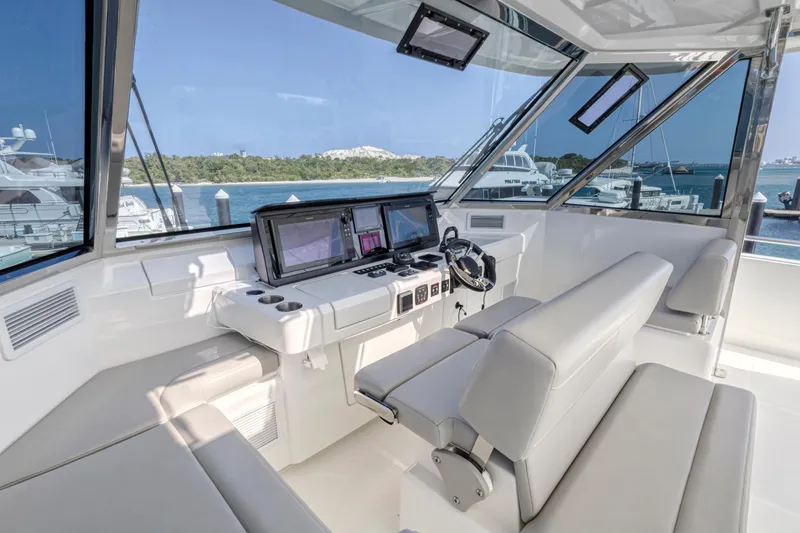 Slide: The Image of Outdoor kitchen on 2023 Aquila 54 Yacht with grill and storage, overlooking marina. - 8