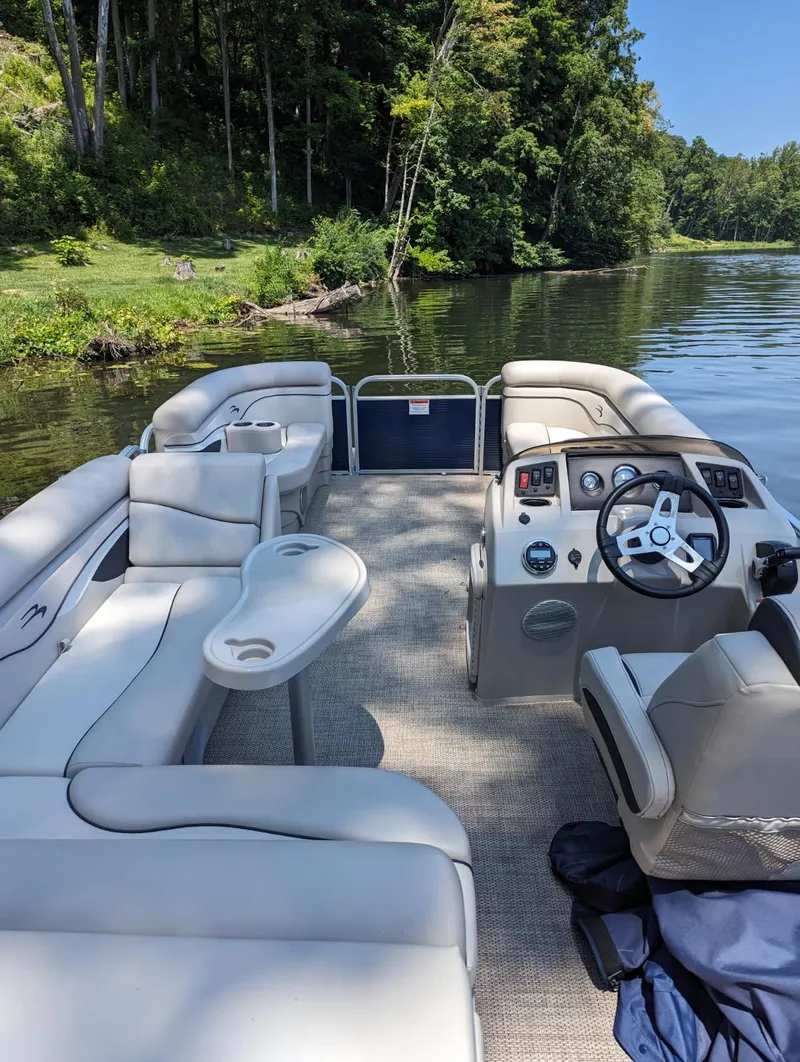 Slide: The Image of 2020 Bennington 20SLV pontoon boat on a serene lake with lush greenery. - 3