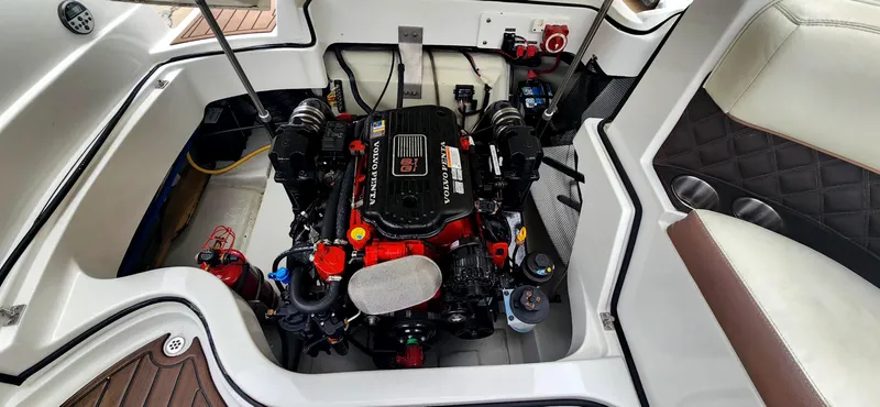 Slide: The Image of 2011 Cobalt 242 boat engine compartment with detailed view of engine components. - 11