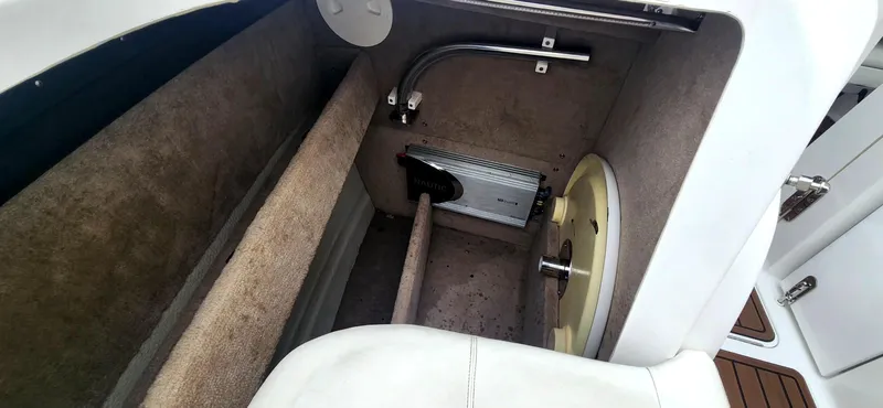 Slide: The Image of Storage compartment in a 2011 Cobalt 242 boat, featuring interior equipment and fittings. - 12