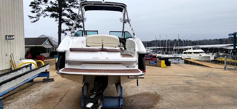 Slide: The Image of 2011 Cobalt 242 boat on trailer at marina, surrounded by other boats. - 3