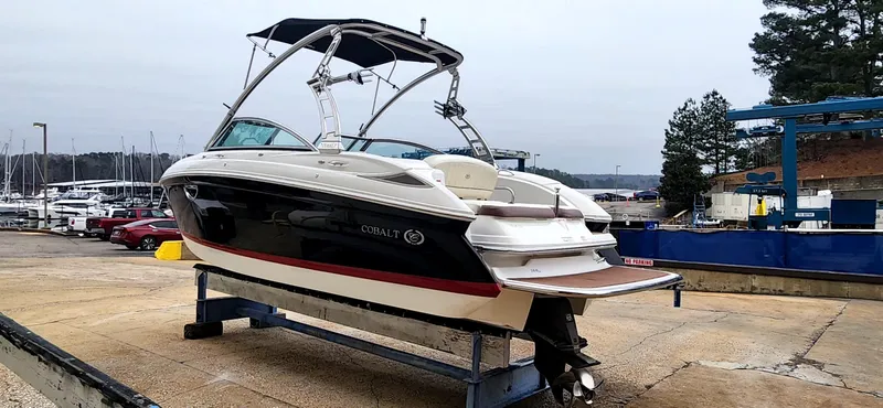 Slide: The Image of 2011 Cobalt 242 boat on a stand at a marina, ready for launch. - 4