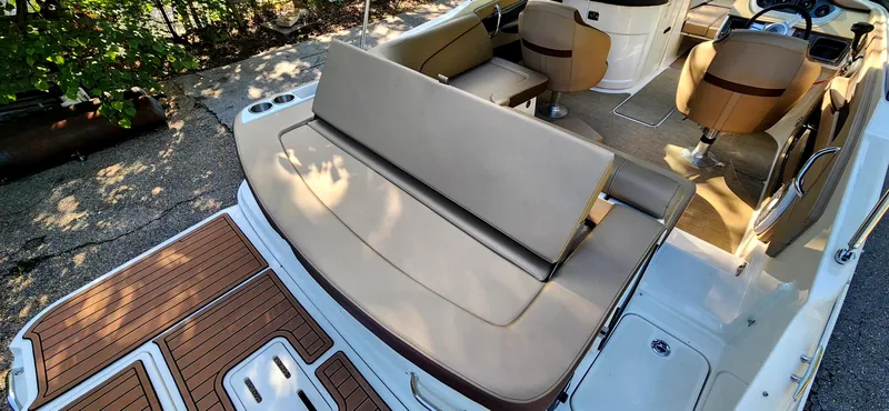 Slide: The Image of 2017 Sea Ray SDX 220 boat interior with tan seating and wood accents. - 10