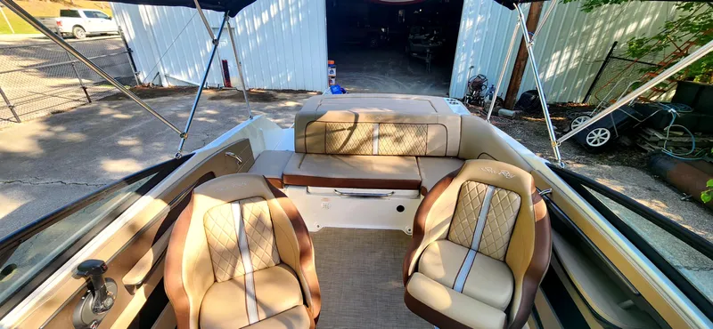 Slide: The Image of 2017 Sea Ray SDX 220 boat interior with tan seating and open canopy. - 12