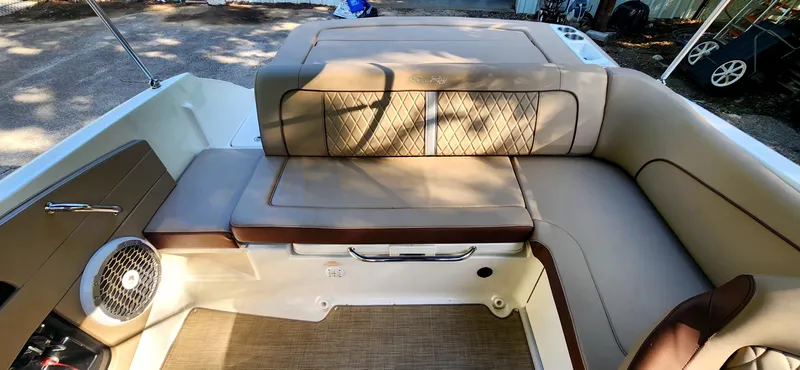 Slide: The Image of 2017 Sea Ray SDX 220 boat interior with beige seating and speaker. - 13
