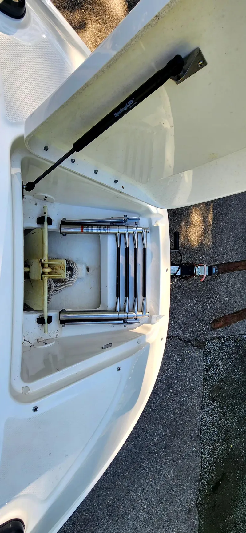 Slide: The Image of 2017 Sea Ray SDX 220 boat ladder compartment, open hatch, and hydraulic support. - 17