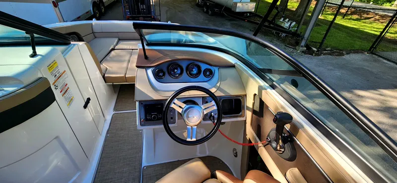 Slide: The Image of 2017 Sea Ray SDX 220 boat interior with steering wheel and dashboard controls. - 18