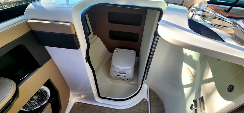 Slide: The Image of 2017 Sea Ray SDX 220 boat interior with compact marine toilet. - 19