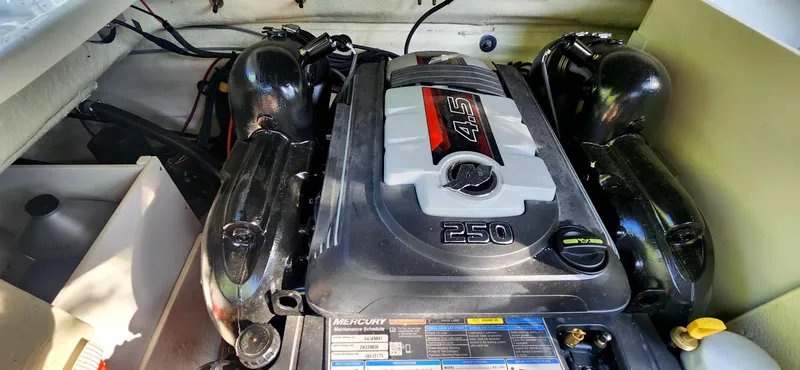 Slide: The Image of Engine compartment of 2017 Sea Ray SDX 220 boat, featuring a Mercury 4.5L 250 HP engine. - 21
